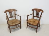 pair of antique chairs with cane back and seat cushions