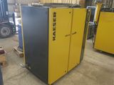 a couple of air compressors sitting in a warehouse next to other machines