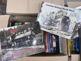 many books in a cardboard box on the floor