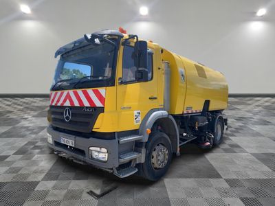 a large yellow truck that is parked in a room