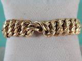 a close up of a gold bracelet on a mannequin mannequin