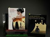 two books are sitting on a table in front of a black background