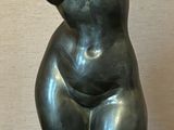 a bronze sculpture of a bear sitting on a table