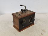 a small wooden box with two knobs on top of it