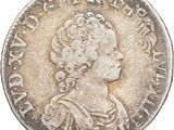 an old silver coin with a woman ' s head on it