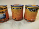 three tins of paint sitting on top of a white surface