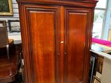 a large wooden cabinet in the corner of a room