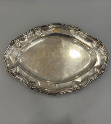 a silver plate with a decorative design on the edge