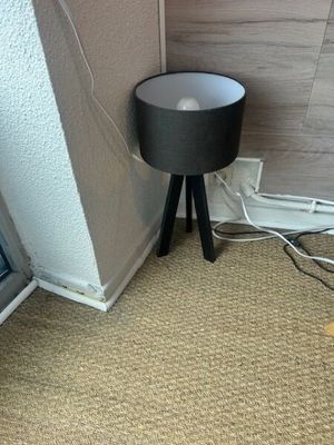 a lamp that is sitting on the floor next to a window