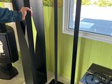 a man that is standing next to a tall speaker
