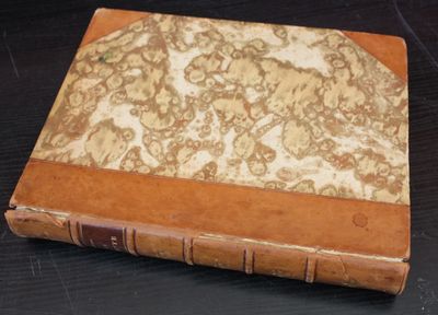 an old book that is sitting on a table