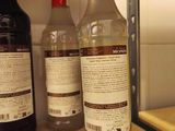 three bottles of alcohol sitting on a counter next to each other