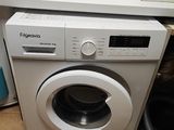a white washing machine sitting on top of a kitchen counter