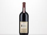 a bottle of red wine sitting on top of a table