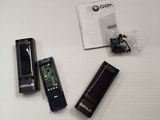 two remotes and a charger sitting on a table