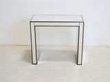 a clear glass table with a black stripe on the top