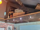 a room with a brick wall and a ceiling with exposed beams