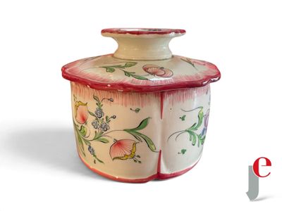 a white and red jar with flowers on it