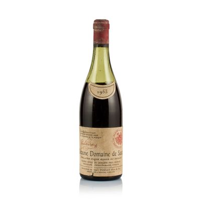 the bottle of wine is sitting on a white surface