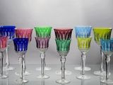 several different colored wine glasses are lined up on a table