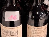 several bottles of wine are lined up on a shelf