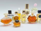 many different types of perfume bottles on a white surface