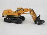 a toy excavator that is sitting on a white surface