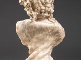 a white marble bust of a woman on a pedestal