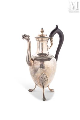 an antique silver tea pot with a black handle sitting on a stand