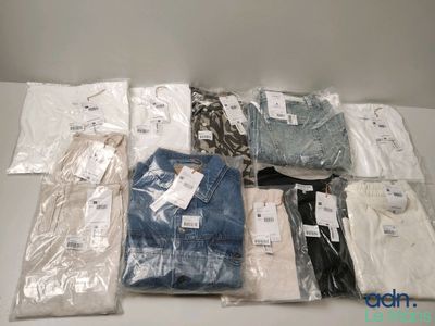 a lot of men ' s shirts in bags on the table