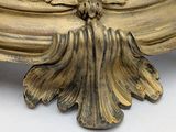 a gold vase with a flower on top of it