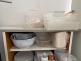 a shelf with dishes and bowls on it in the kitchen