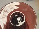 a wine glass sitting on a table next to a bowl