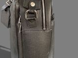 leather bag with a zipper on the side and a metal handle