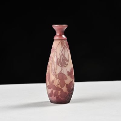 purple glass vase on a white table with a black background