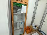 a refrigerator that is inside of a building with boxes in front of it