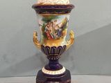 a vase that has a painting on it on display
