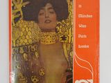 an orange book with a picture of a woman in a gold dress