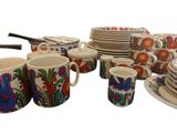 many plates and cups that are sitting on a table