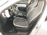 the interior of a small white car with black seats and a steering wheel