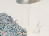 a bird that is sitting on a piece of paper next to a lamp