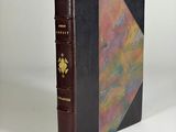 an old book with a brown cover and a black binding