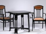 two chairs and a table that are sitting on a white surface