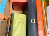 a box of books and a purse sitting on a table