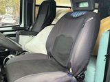 a seat in the back of a van with a surfboard on the back of it