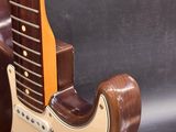 guitar stand made of wood and metal with a guitar on top of it