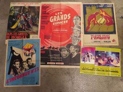 several movie posters on the floor in a room