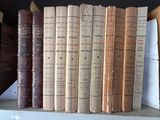many old books sitting on a shelf in a library