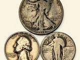 a close up of three different coins on a white surface