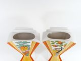 two white vases with orange and yellow designs on them
